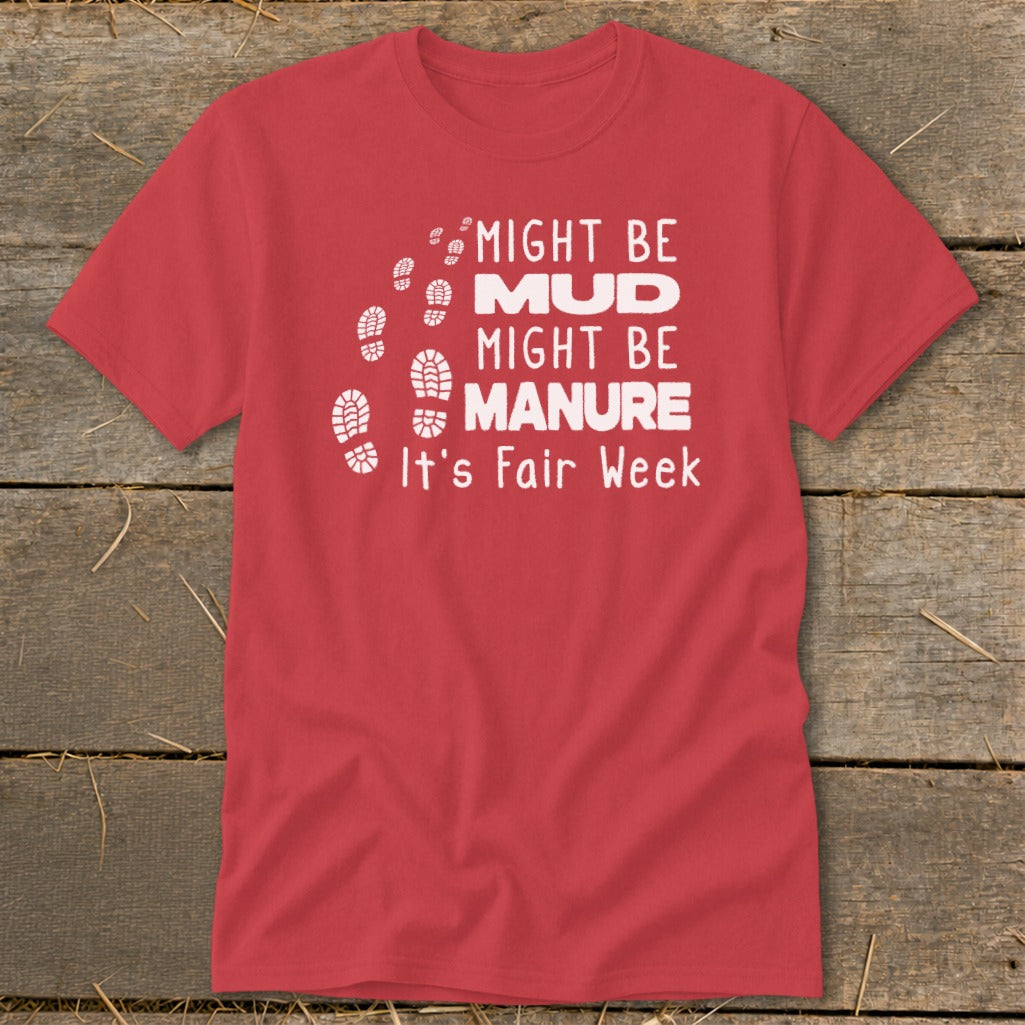 Red t-shirt with "Might Be Mud, Might Be Manure, It's Fair Week" text and footprints.