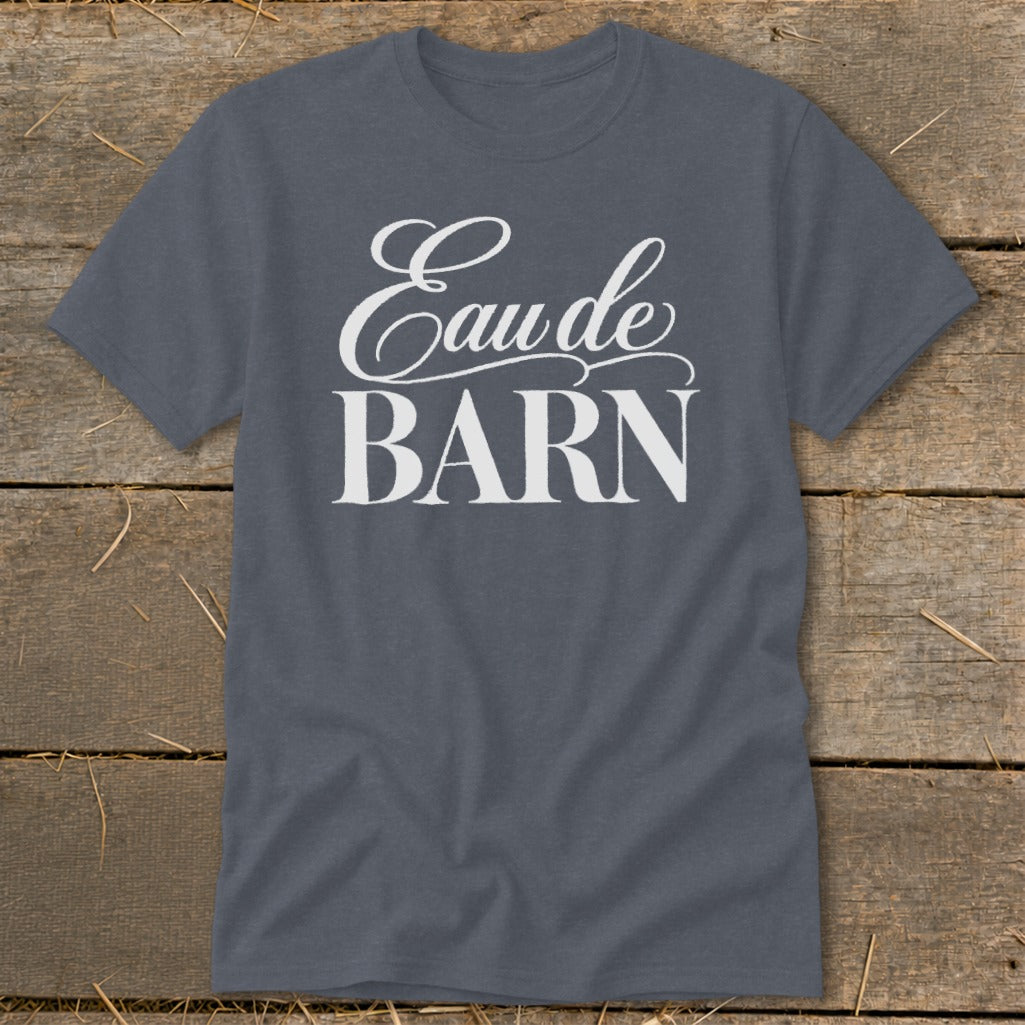 Grey t-shirt with "Eau de BARN" text in white on wood background