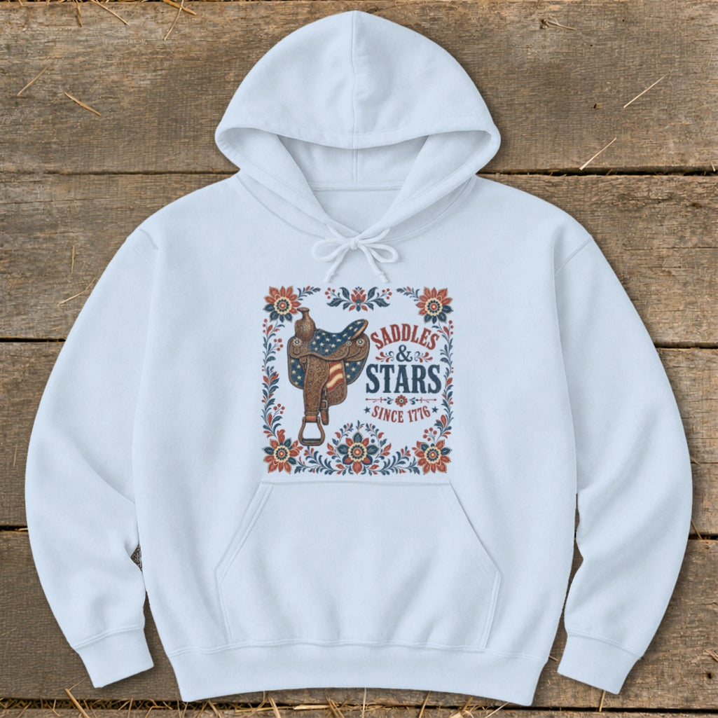 White hoodie with "Saddles & Stars Since 1776" graphic and American flag saddle.