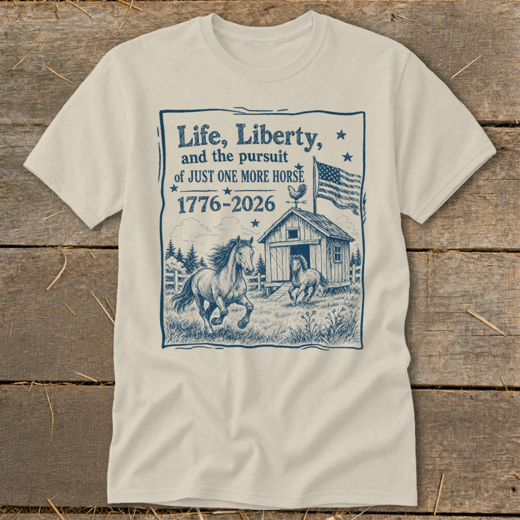T-shirt with blue graphic: "Life, Liberty, and the pursuit of JUST ONE MORE HORSE 1776-2026" with horses.
