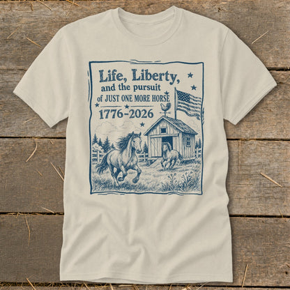T-shirt with blue graphic: "Life, Liberty, and the pursuit of JUST ONE MORE HORSE 1776-2026" with horses.