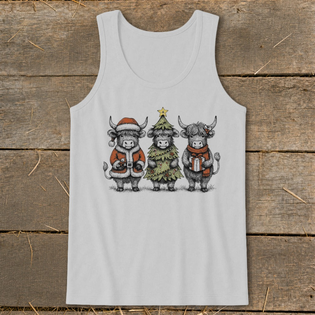 Three Highland cows dressed for Christmas: one as Santa, one as a tree, one with a gift.
