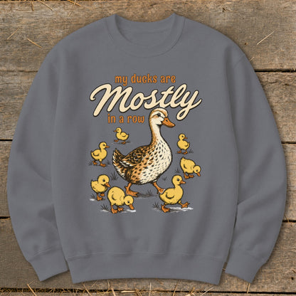 Crewneck sweatshirt with illustration of a mother duck and ducklings, with text "my ducks are Mostly in a row".