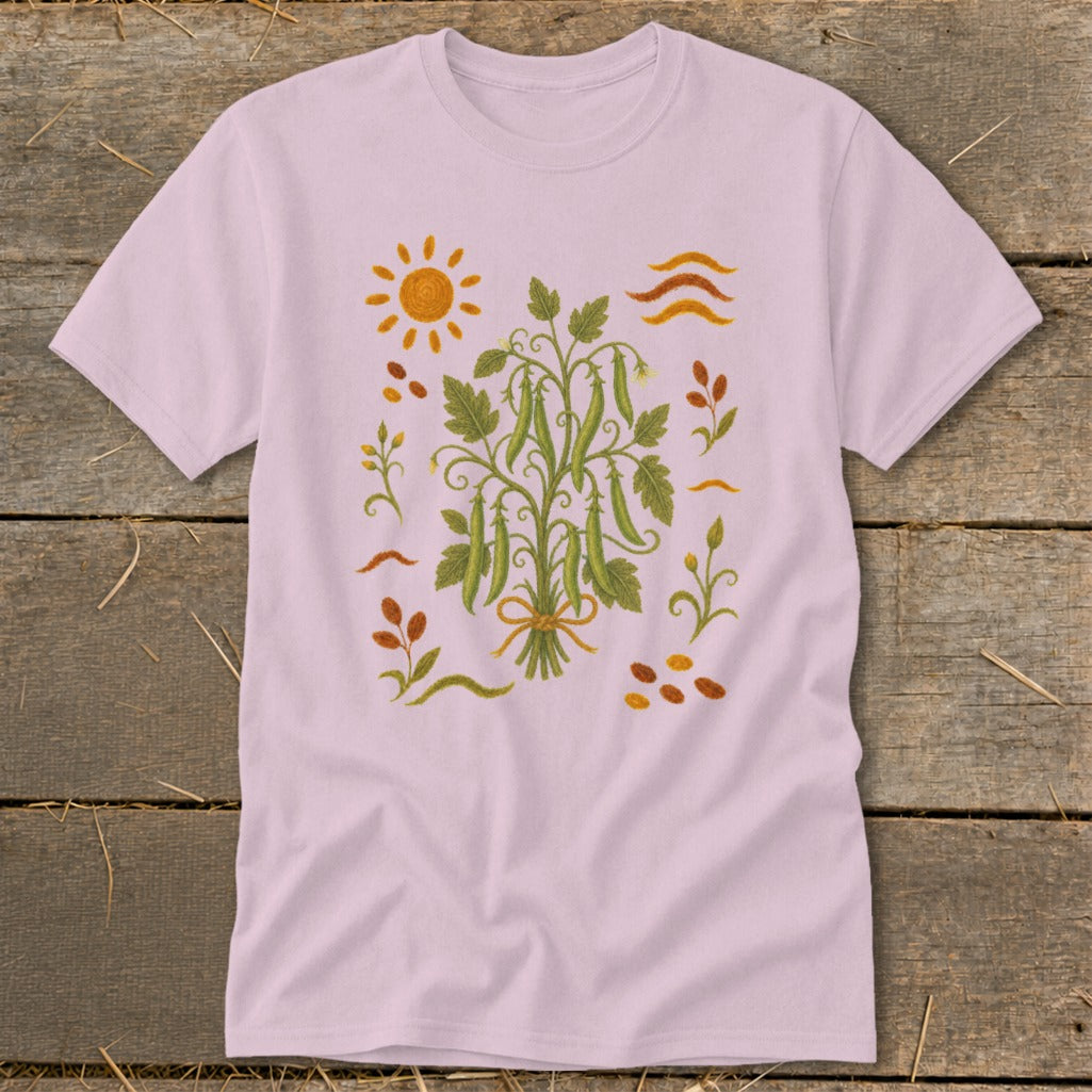 Pink t-shirt with a central pea vine illustration and surrounding sun and bean motifs.