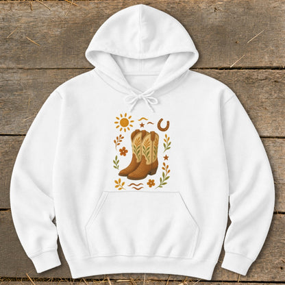 White hoodie with a graphic featuring cowboy boots, sun, horseshoe, and floral elements.