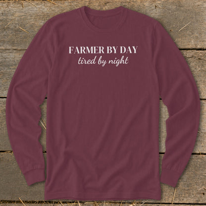 Maroon long-sleeve shirt with white text "Farmer by day tired by night".