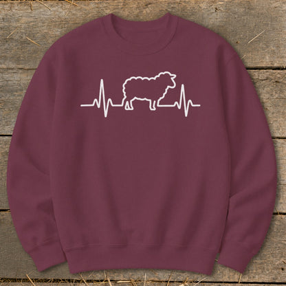 Maroon crewneck sweatshirt featuring a white graphic of a sheep silhouette integrated into a heartbeat line.