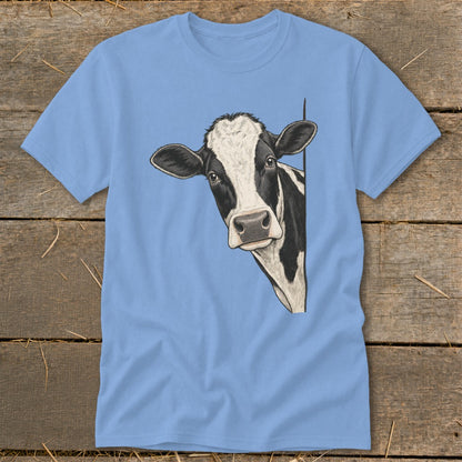 Black and white cow peeking from behind a blue t-shirt.