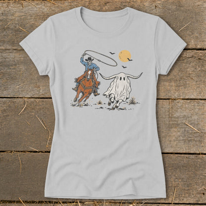 Skeleton cowboy on horseback lassoing a ghost longhorn with bats and a full moon.