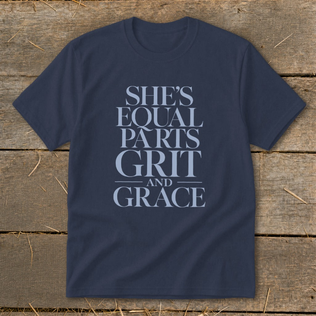 Navy t-shirt with light blue text: "She's equal parts grit and grace."