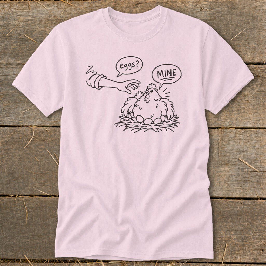 Pink t-shirt with black line art of a chicken protecting eggs, labeled "Mine."