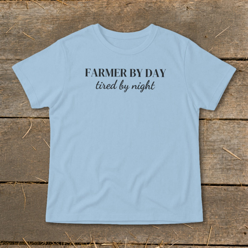 Light blue t-shirt with black text reading "FARMER BY DAY tired by night".
