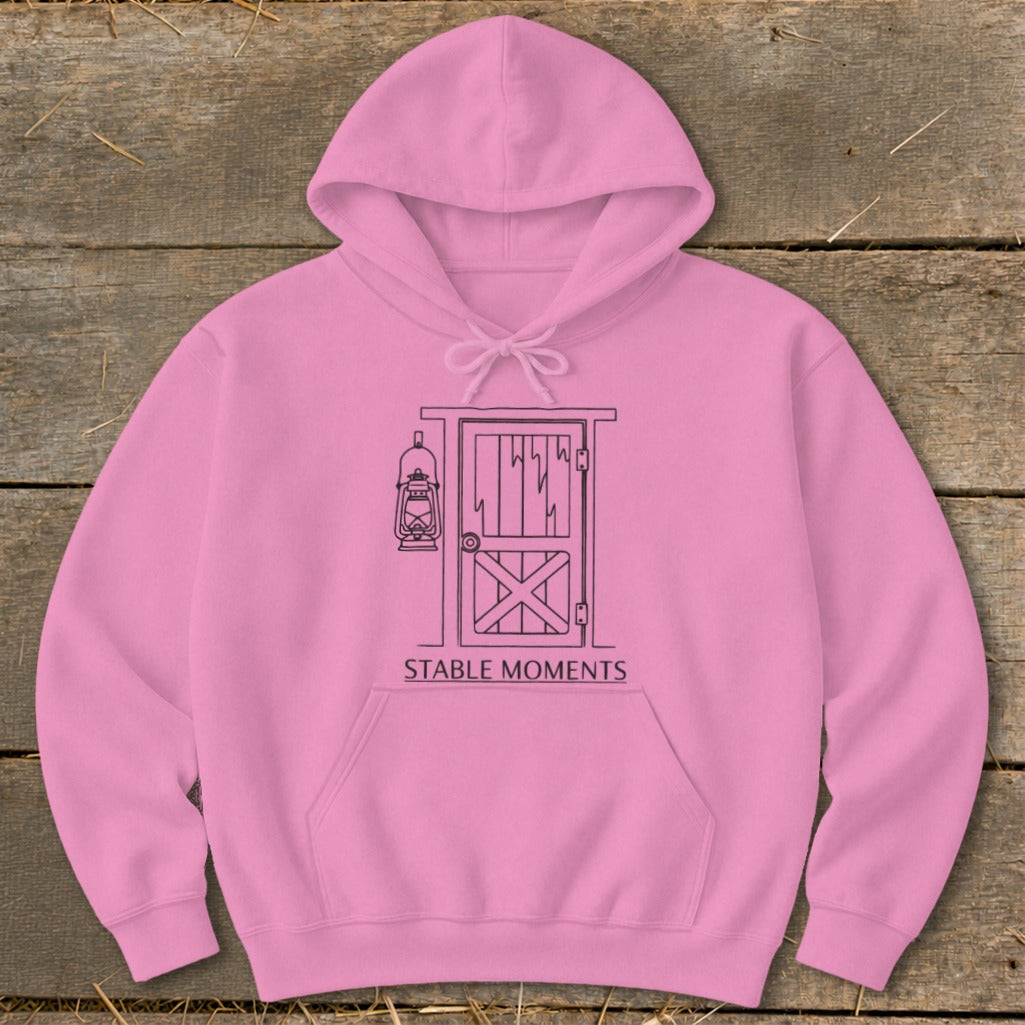 Pink hoodie with black line drawing of a barn door, lantern, and "STABLE MOMENTS" text.