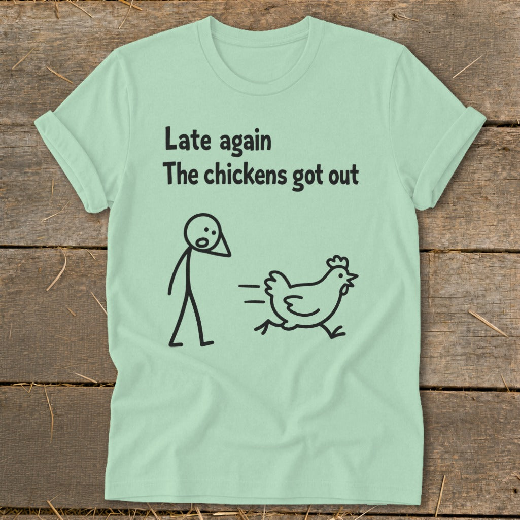 Light green t-shirt with black text and stick figures of a person and a running chicken.