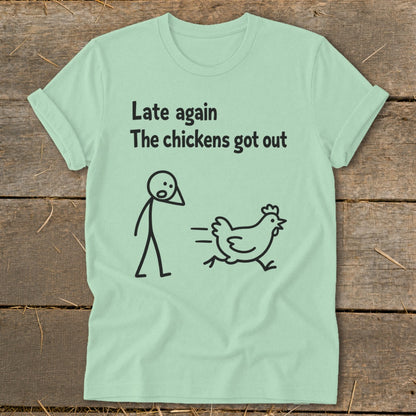 Light green t-shirt with black text and stick figures of a person and a running chicken.