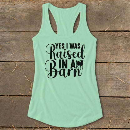 Light green tank top with black text and goat graphic saying "Yes I Was Raised In A Barn".