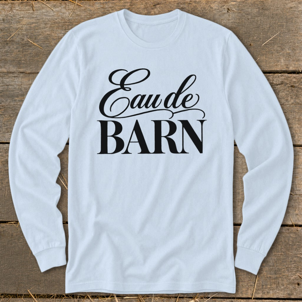 Light blue long sleeve shirt with "Eau de BARN" text in black script and block letters.