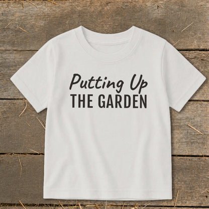 White t-shirt with "Putting Up THE GARDEN" text in black.