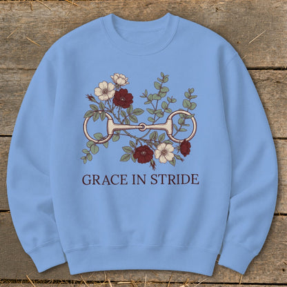 Light blue crewneck sweatshirt with floral and horse bit graphic and text "GRACE IN STRIDE".