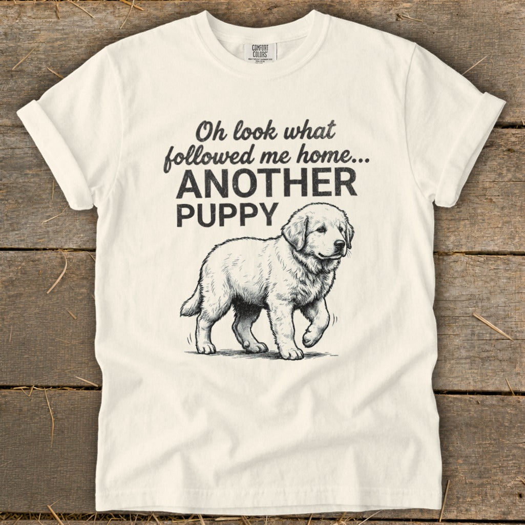Cream t-shirt with black text and sketch of a puppy: "Oh look what followed me home... ANOTHER PUPPY"