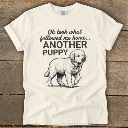 Cream t-shirt with black text and sketch of a puppy: "Oh look what followed me home... ANOTHER PUPPY"
