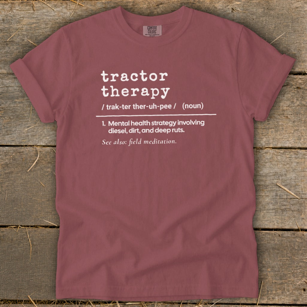 Maroon t-shirt with white text defining "tractor therapy."