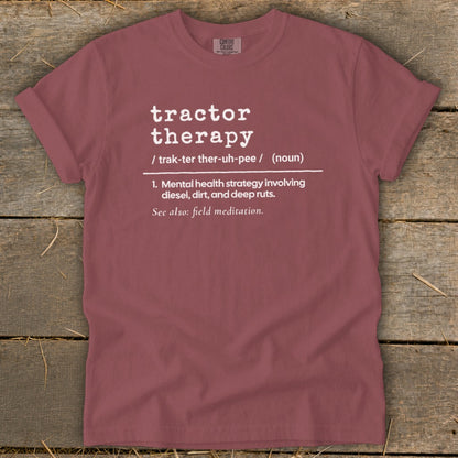 Maroon t-shirt with white text defining "tractor therapy."