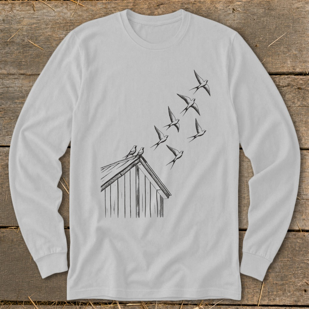 Light gray long-sleeve t-shirt featuring a line drawing of birds flying from a rooftop.