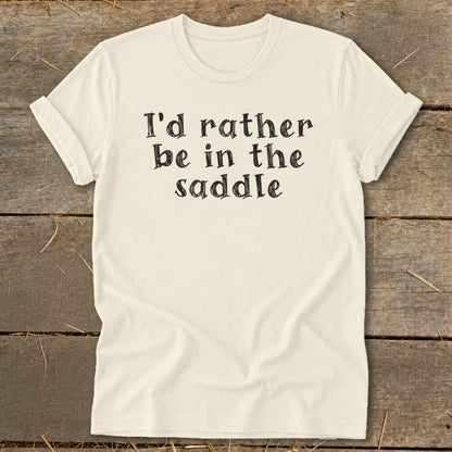 Cream t-shirt with "I'd rather be in the saddle" printed in black text.