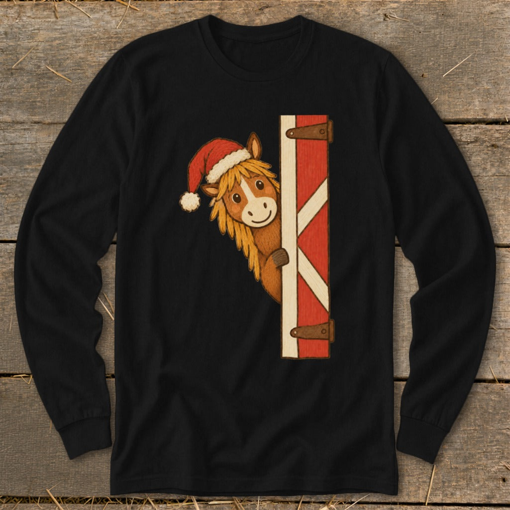 Christmas horse wearing Santa hat peeking around barn door on black long sleeve shirt.