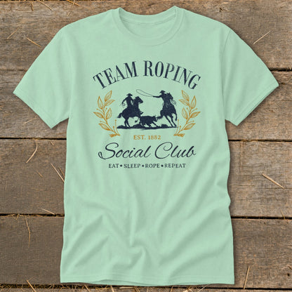 Mint green t-shirt with "Team Roping Social Club" graphic and horses.