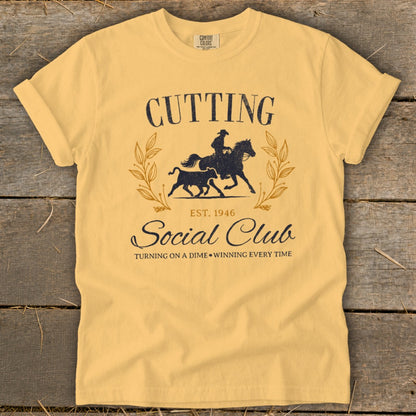 Yellow t-shirt with "Cutting Social Club est. 1946" and cowboy on horse chasing bull.