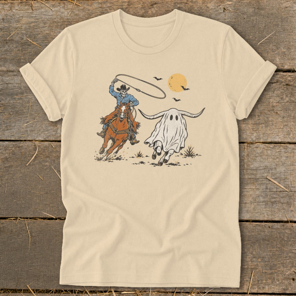 Skeleton cowboy on horseback lassos a ghost with bull horns under a setting sun.