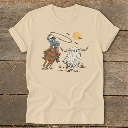 Skeleton cowboy on horseback lassos a ghost with bull horns under a setting sun.
