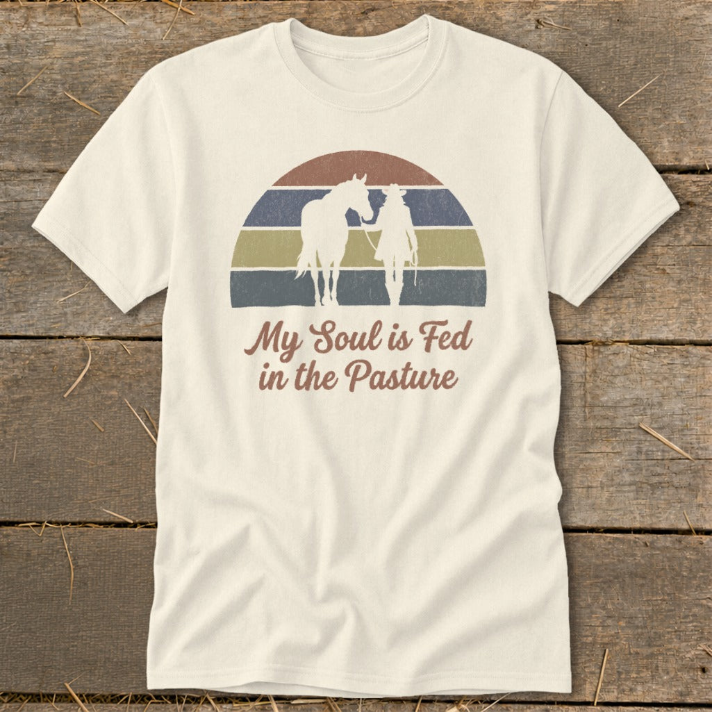 T-shirt with silhouette of horse and rider, text "My Soul is Fed in the Pasture".