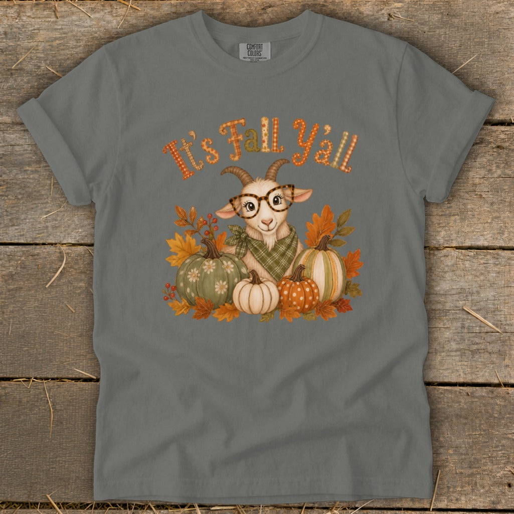 Goat with glasses and pumpkins on t-shirt with "It's Fall Y'all" text.