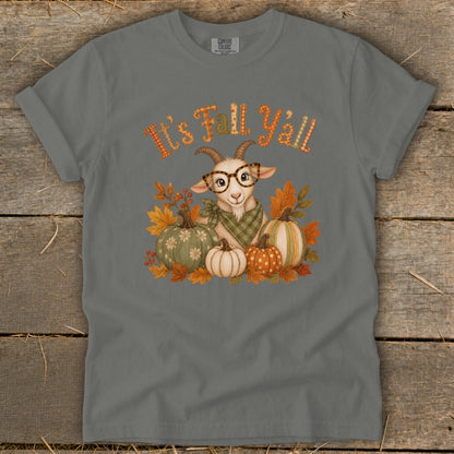 Goat with glasses and pumpkins on t-shirt with "It's Fall Y'all" text.