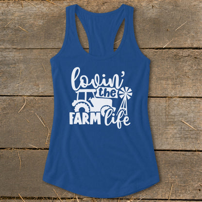 Blue tank top with white "Lovin' the Farm Life" text, tractor, and windmill graphic.