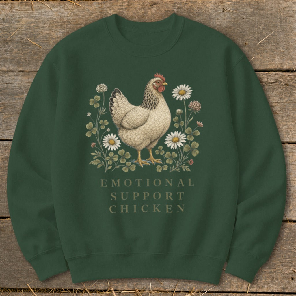 Green sweatshirt with a white chicken illustration surrounded by clover and daisies, text reads "EMOTIONAL SUPPORT CHICKEN".