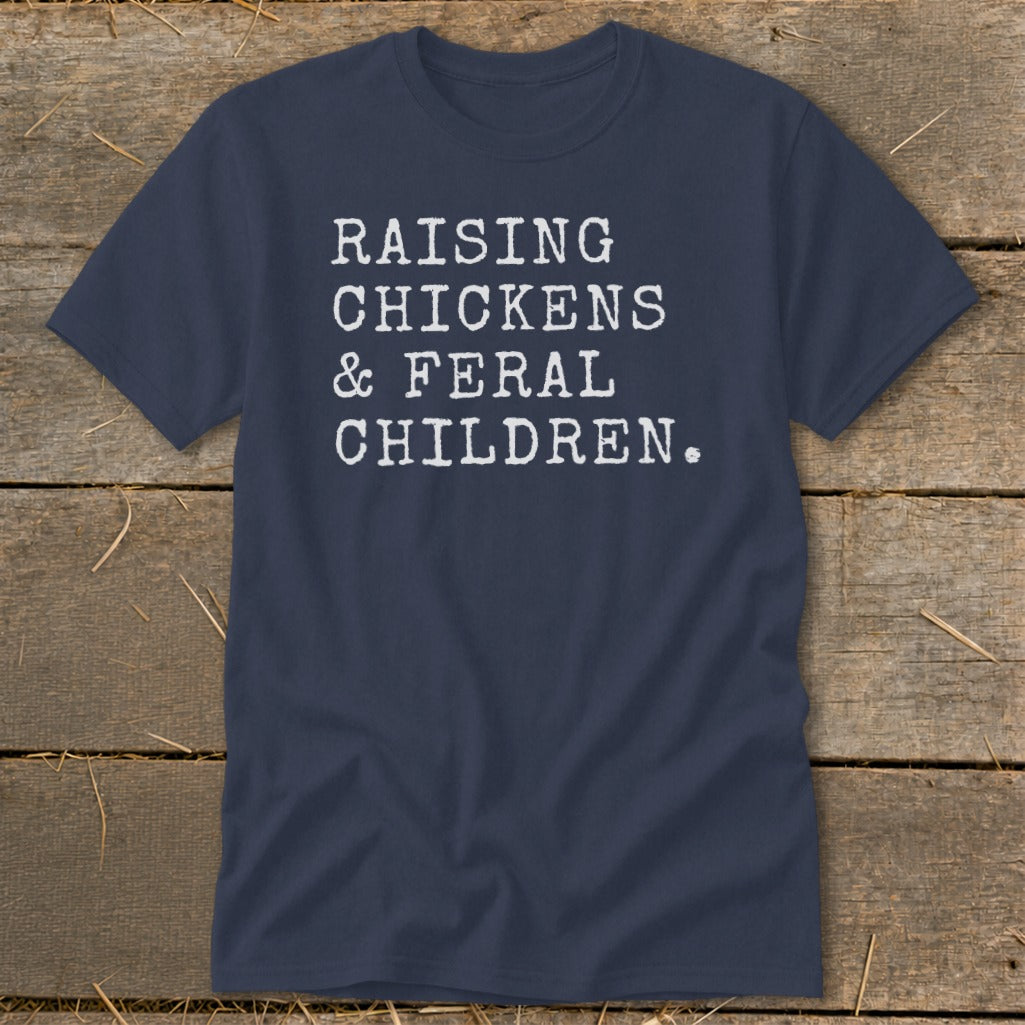 Navy t-shirt with white text reading "RAISING CHICKENS & FERAL CHILDREN."