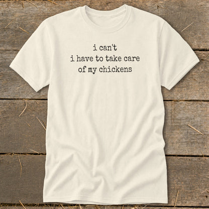 Cream t-shirt with black text "I can't i have to take care of my chickens."