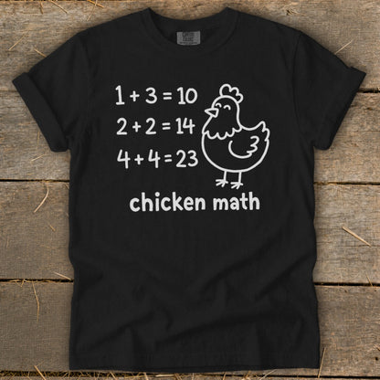 Black t-shirt with white text and chicken graphic: "1+3=10, 2+2=14, 4+4=23 chicken math."