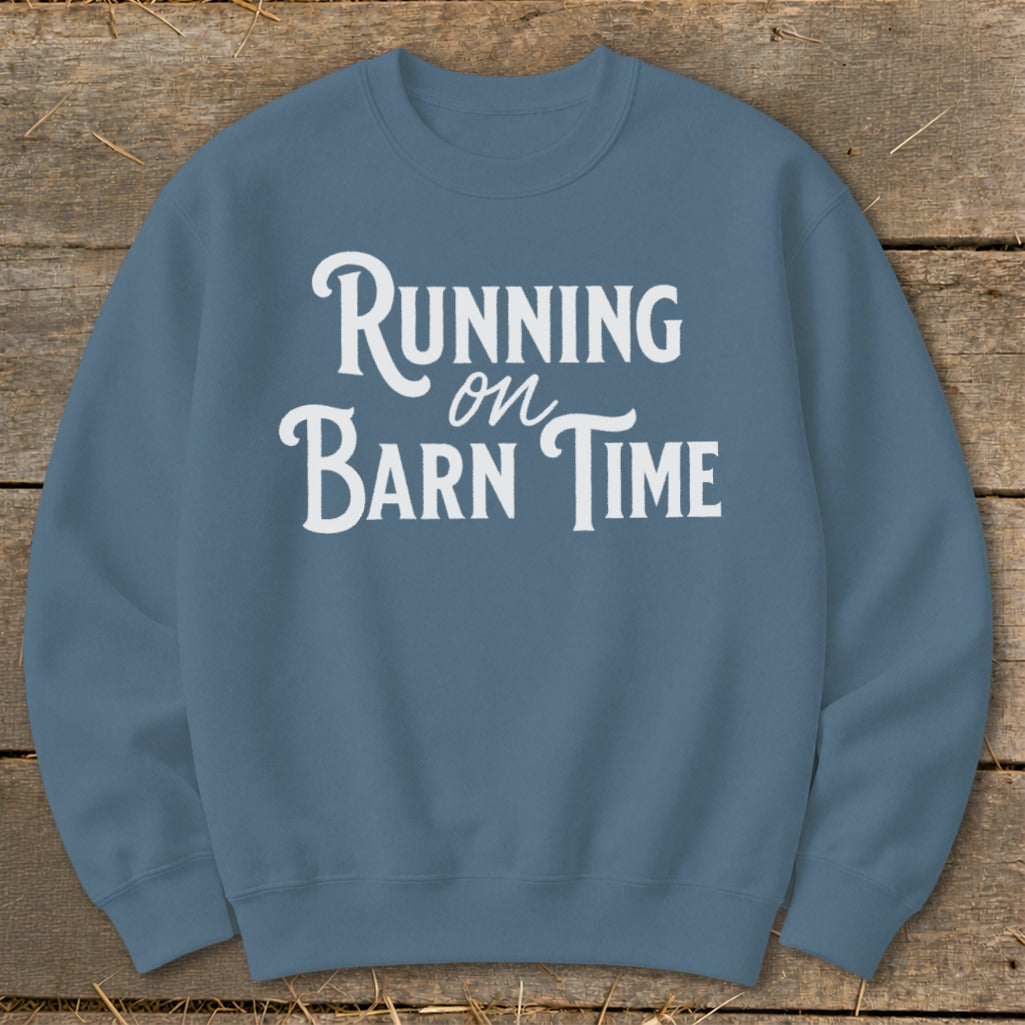 Blue sweatshirt with white text that reads "Running on Barn Time".