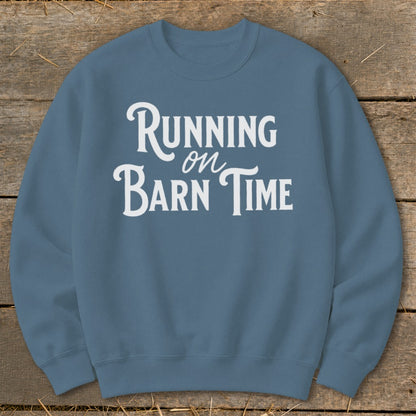 Blue sweatshirt with white text that reads "Running on Barn Time".