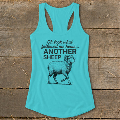 Teal tank top with black graphic of a sheep and text "Oh look what followed me home... ANOTHER SHEEP".