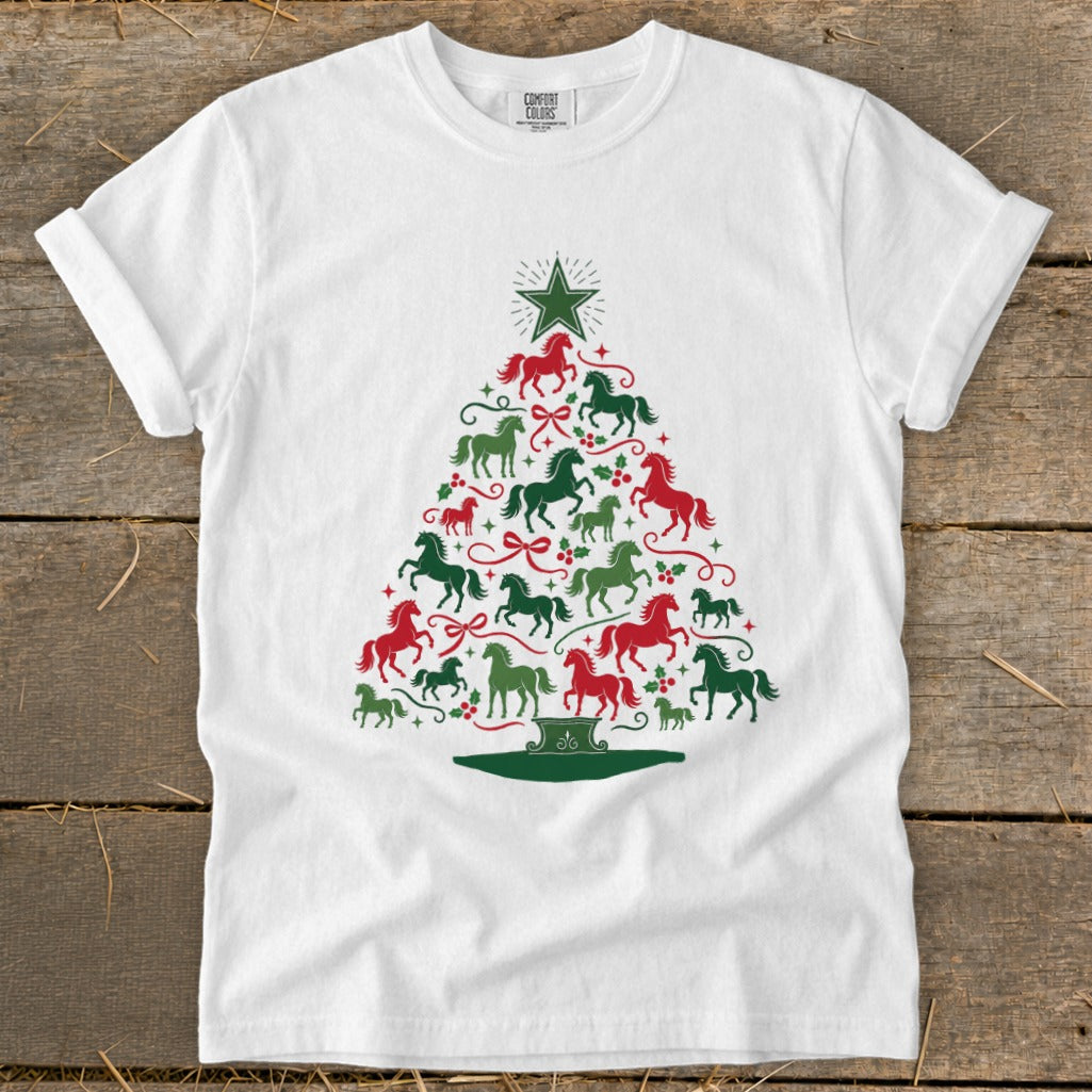 White t-shirt with a Christmas tree design made of red and green horses and holly.