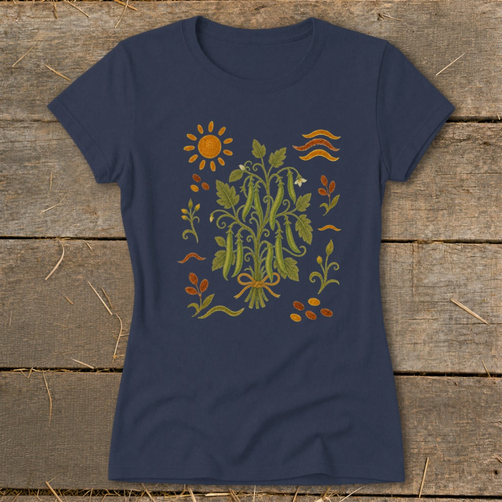 Navy t-shirt with a central illustration of a pea plant tied with a ribbon, surrounded by sun and seeds.