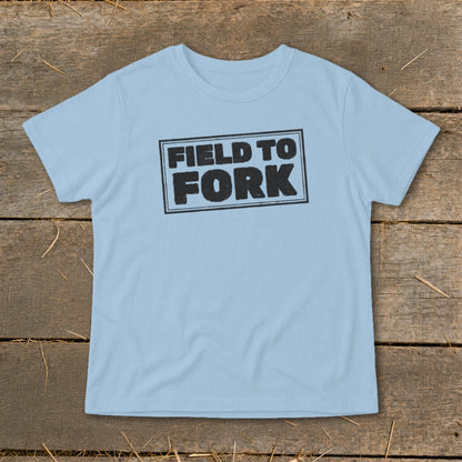 Light blue t-shirt featuring a black rectangle stamp with the words Field To Fork displayed centrally.