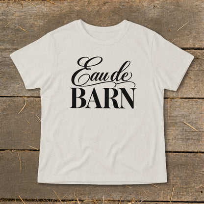 Light-colored t-shirt with "Eau de BARN" text in black script and serif fonts.