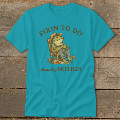 Teal t-shirt with frog in rocking chair, "Fixin to do absolutely NOTHIN" text.